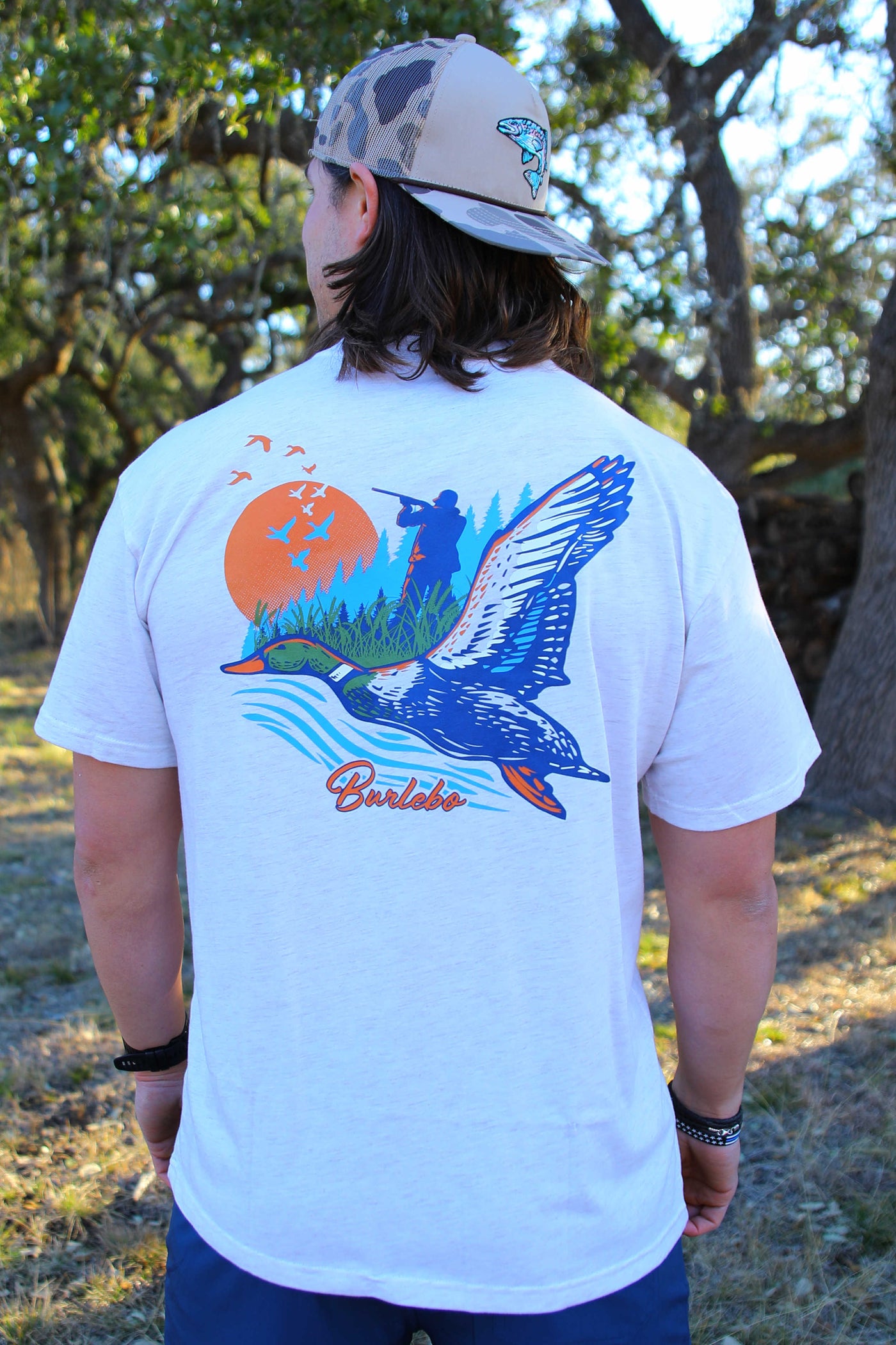 Light grey tshirt with a duck and a hunter on the back
